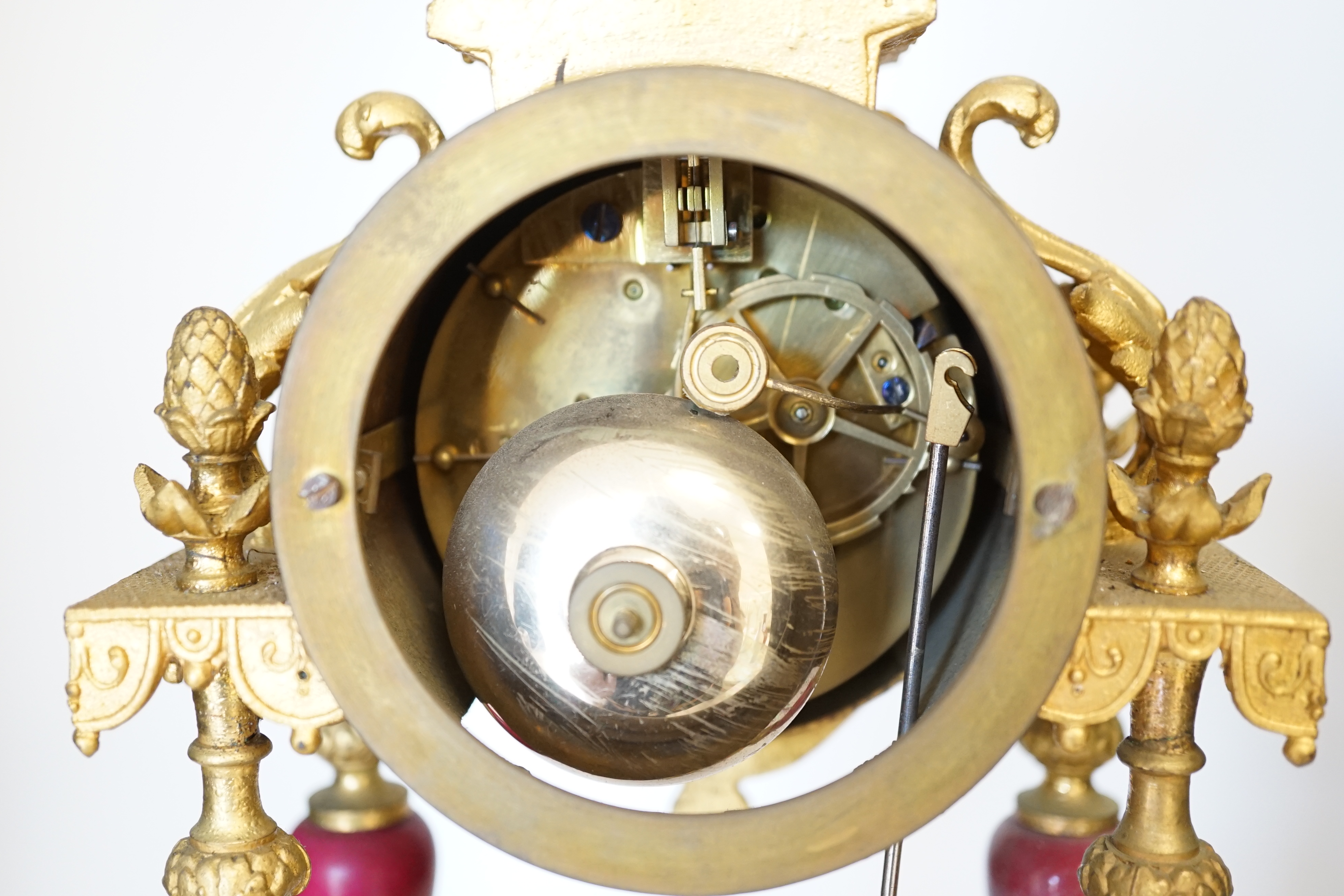 A late 19th century gilt metal and porcelain mounted mantel clock with associated stand, key and pendulum, 46cm. Condition - good to fair, not tested
